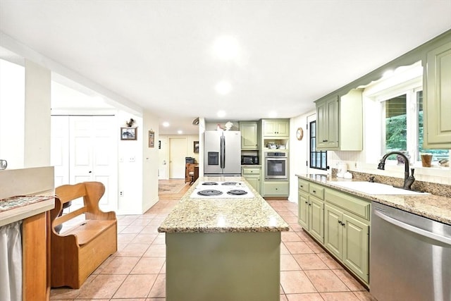 23 Westboro Rd, Upton, MA 01568 - kitchen with green cabinetry, stainless steel appliances, a center island, light tile patterned floors, and recessed lighting