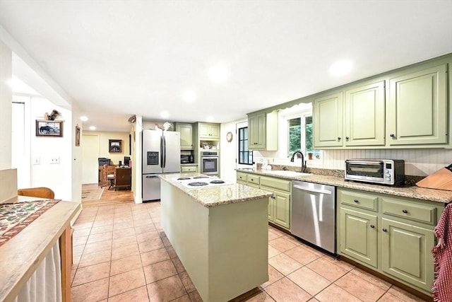 23 Westboro Rd, Upton, MA 01568 - kitchen with green cabinetry, appliances with stainless steel finishes, a center island, recessed lighting, and light stone countertops