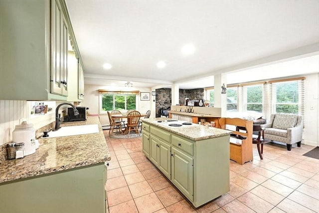 23 Westboro Rd, Upton, MA 01568 - kitchen with green cabinetry, light tile patterned flooring, a kitchen island, white electric stovetop, and recessed lighting