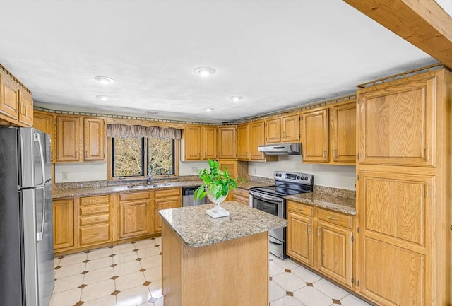 6 Boyd Dr, Newburyport, MA 01950 - kitchen with appliances with stainless steel finishes, under cabinet range hood, a kitchen island, light stone countertops, and light flooring