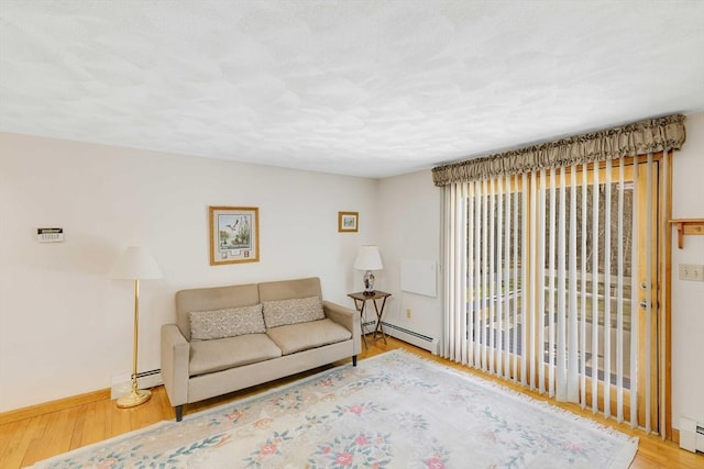 6 Boyd Dr, Newburyport, MA 01950 - living area featuring a baseboard heating unit, wood finished floors, and baseboard heating
