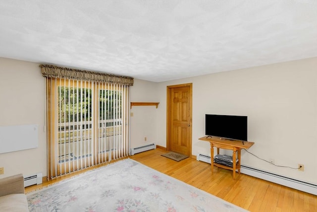 6 Boyd Dr, Newburyport, MA 01950 - unfurnished living room featuring a baseboard radiator and wood finished floors