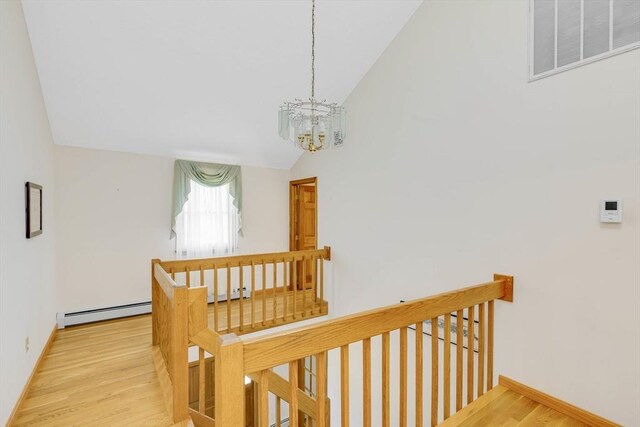 6 Boyd Dr, Newburyport, MA 01950 - stairway featuring a chandelier, a baseboard radiator, vaulted ceiling, wood finished floors, and a baseboard heating unit