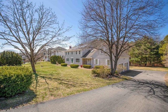 6 Boyd Dr, Newburyport, MA 01950 - colonial house with asphalt driveway, an attached garage, a chimney, and a front lawn