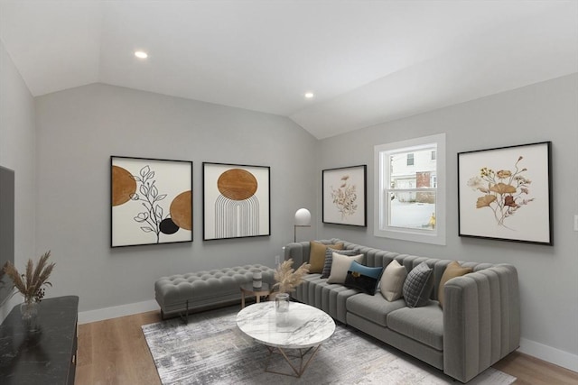 living room featuring lofted ceiling and light wood-type flooring