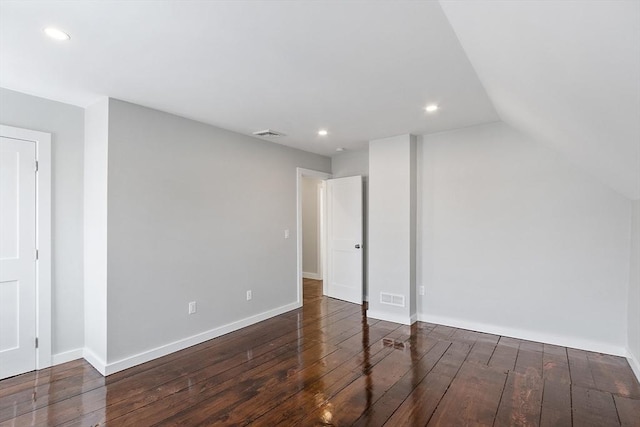 bonus room featuring lofted ceiling and dark wood-type flooring