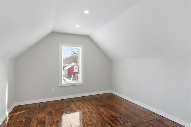 additional living space with lofted ceiling and dark hardwood / wood-style floors