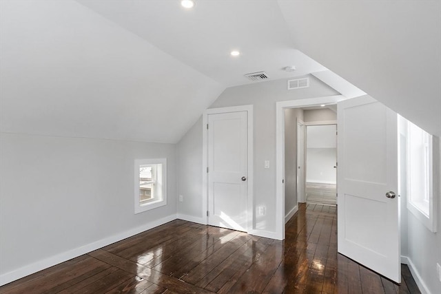 additional living space with lofted ceiling and dark hardwood / wood-style flooring