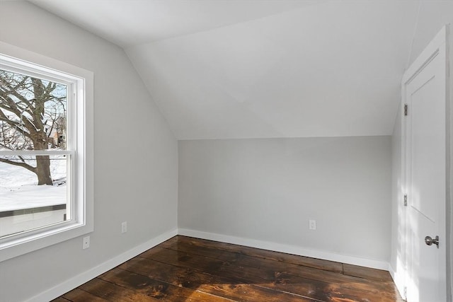 bonus room with lofted ceiling and dark hardwood / wood-style flooring