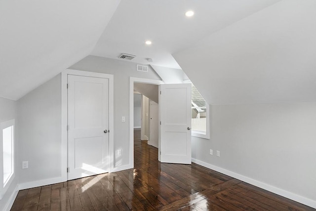 additional living space featuring vaulted ceiling and dark hardwood / wood-style floors