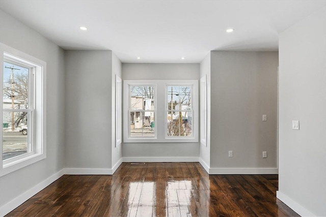 unfurnished room with dark wood-type flooring