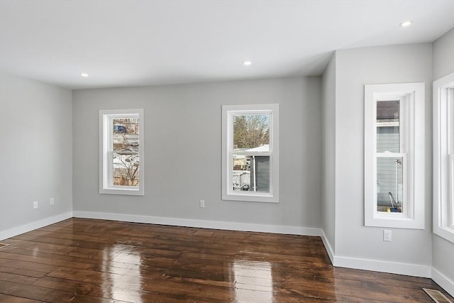 unfurnished room featuring dark wood-type flooring