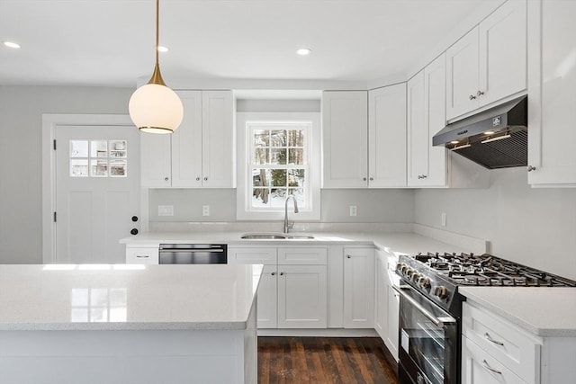 kitchen featuring decorative light fixtures, sink, range with gas cooktop, and white cabinets