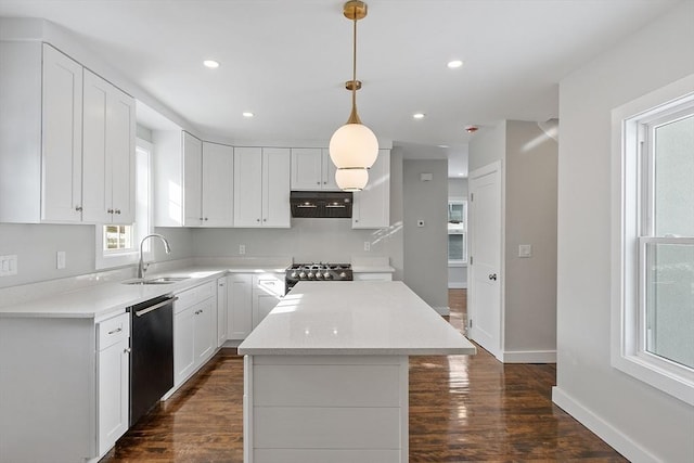 kitchen featuring sink, dishwasher, range, hanging light fixtures, and white cabinets