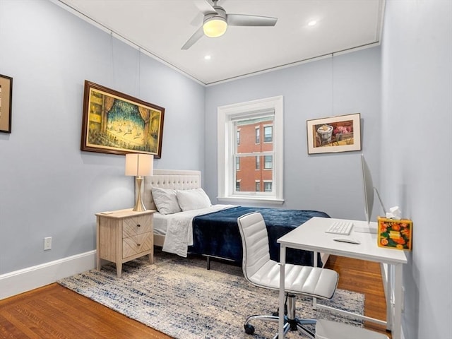 bedroom with ceiling fan, crown molding, and wood-type flooring