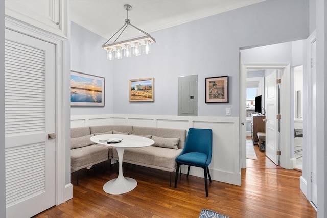 sitting room featuring electric panel, crown molding, and wood-type flooring