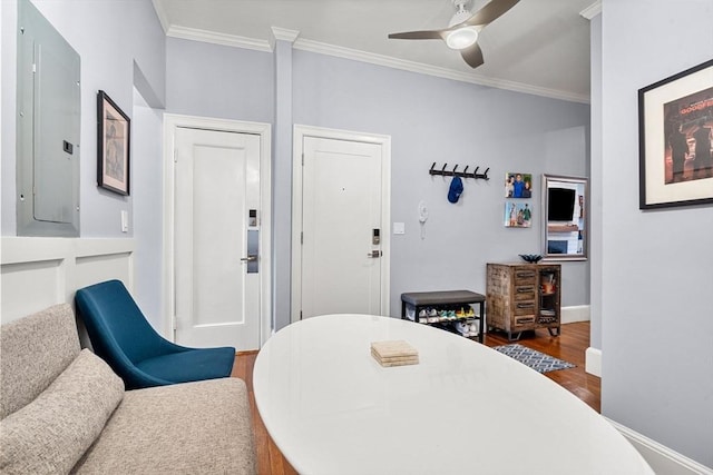 dining space with electric panel, crown molding, ceiling fan, and dark wood-type flooring