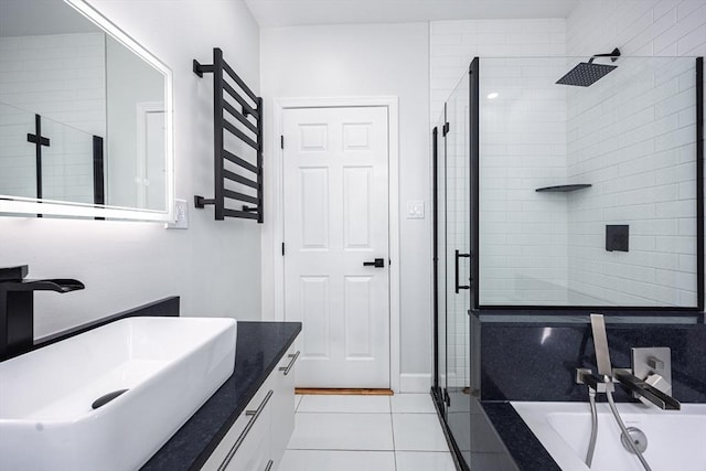 bathroom with tile patterned flooring, a tub, vanity, and a stall shower