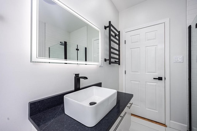 full bath with vanity and tiled shower