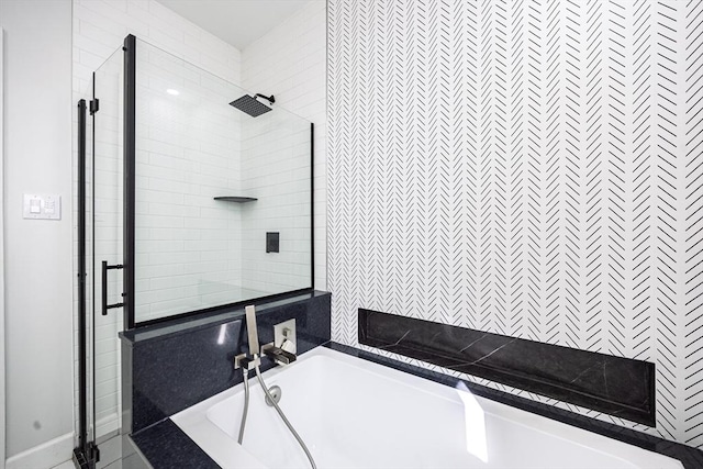 bathroom featuring a stall shower and a bath