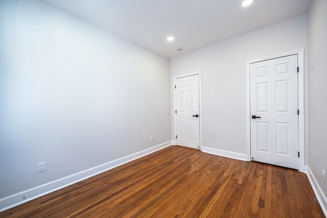 unfurnished bedroom with dark wood-style floors, recessed lighting, and baseboards