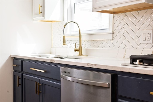 kitchen with decorative backsplash, dishwasher, light stone countertops, and a sink