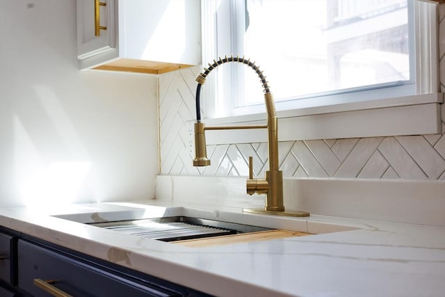 interior details featuring light countertops and a sink