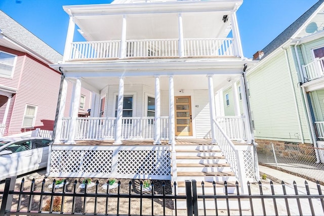 view of front facade featuring covered porch and fence