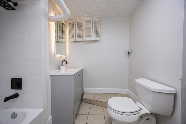 bathroom featuring tile patterned floors, toilet, a textured ceiling, baseboards, and vanity