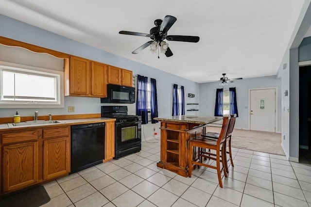 394 Huttleston Ave, Fairhaven, MA 02719 - kitchen with black appliances, brown cabinetry, plenty of natural light, and light countertops
