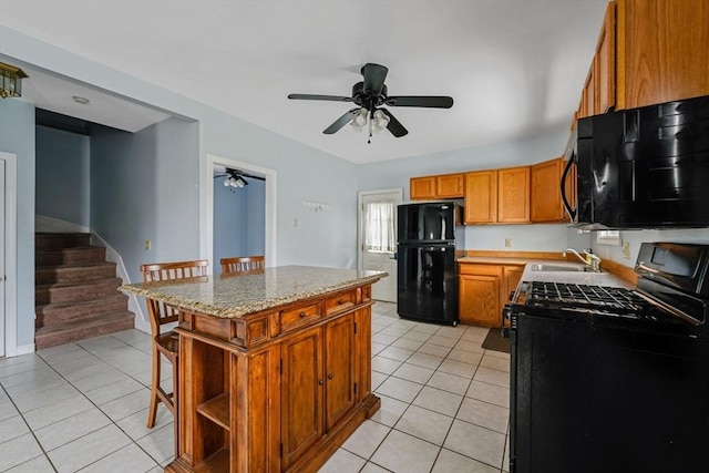 394 Huttleston Ave, Fairhaven, MA 02719 - kitchen with black appliances, light tile patterned floors, a ceiling fan, and a kitchen island