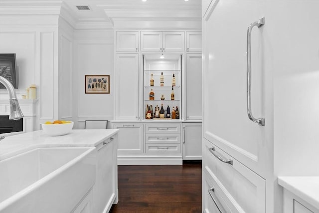 128 Marlborough St Unit 6, Boston, MA 02116 - bar area with a sink, a decorative wall, crown molding, and dark wood-type flooring
