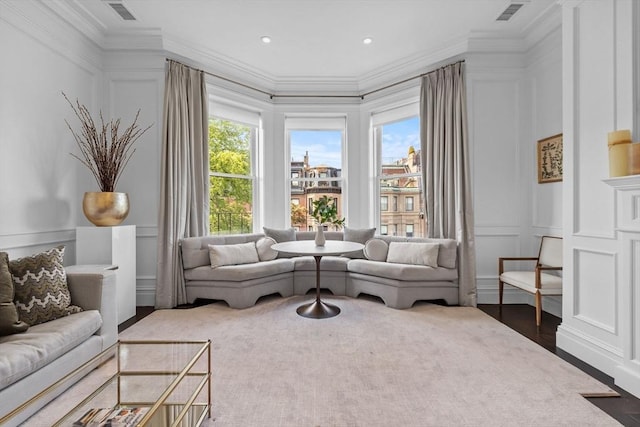 128 Marlborough St Unit 6, Boston, MA 02116 - living area featuring a decorative wall, crown molding, healthy amount of natural light, and wood finished floors