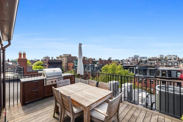 128 Marlborough St Unit 6, Boston, MA 02116 - wooden terrace featuring a view of city, outdoor dining area, and central air condition unit