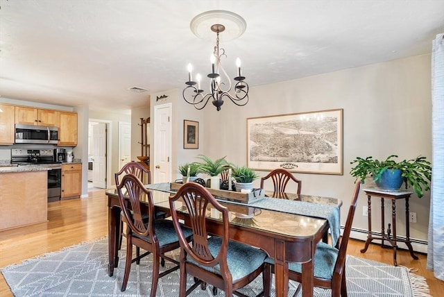 dining space featuring a notable chandelier, light hardwood / wood-style flooring, and baseboard heating