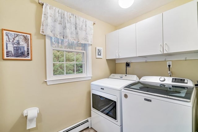 washroom featuring cabinets, a baseboard heating unit, and washer and clothes dryer