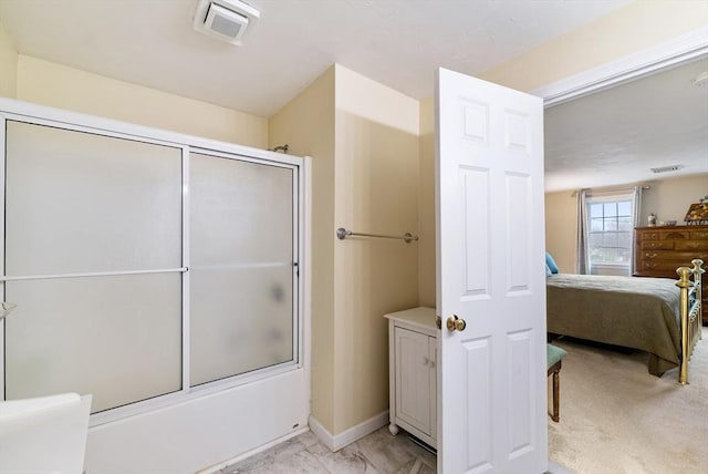 bathroom with bath / shower combo with glass door