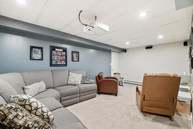 carpeted living room featuring baseboard heating and a drop ceiling