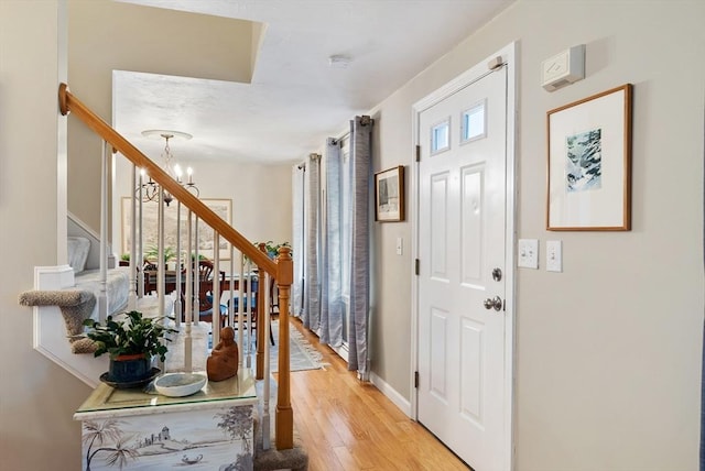 entrance foyer with a chandelier and light hardwood / wood-style floors