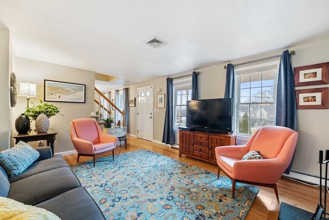 living room with a baseboard radiator and hardwood / wood-style floors