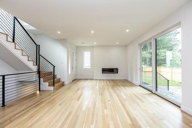 93 Griswold St Unit 93, Cambridge, MA 02138 - unfurnished living room with wood finished floors, healthy amount of natural light, stairway, and recessed lighting
