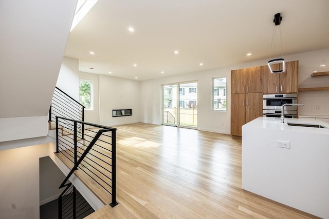 93 Griswold St Unit 93, Cambridge, MA 02138 - kitchen with healthy amount of natural light, light wood-type flooring, brown cabinetry, modern cabinets, and recessed lighting
