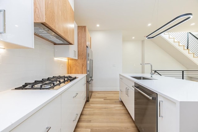 93 Griswold St Unit 93, Cambridge, MA 02138 - kitchen featuring appliances with stainless steel finishes, modern cabinets, a sink, custom exhaust hood, and recessed lighting