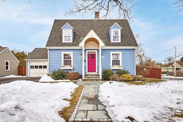 cape cod home with a garage, a chimney, and roof with shingles