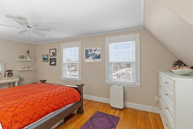 bedroom featuring light wood finished floors, multiple windows, and baseboards