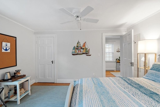 bedroom with baseboards, ornamental molding, and a ceiling fan