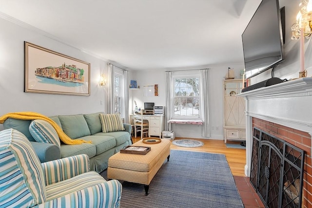 living room featuring a brick fireplace and wood finished floors