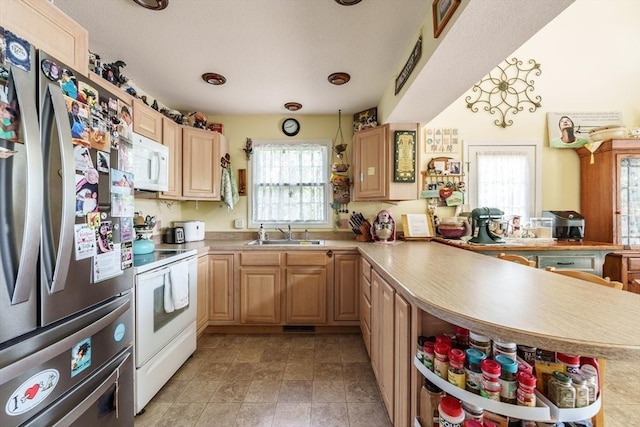 64 Porcupine Point Rd, Tolland, MA 01034 - kitchen with white appliances, a peninsula, a sink, light countertops, and light brown cabinets