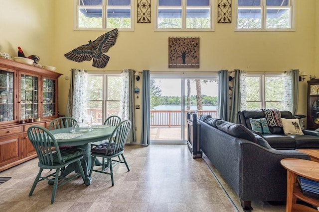 64 Porcupine Point Rd, Tolland, MA 01034 - dining room featuring a high ceiling, healthy amount of natural light, and a water view