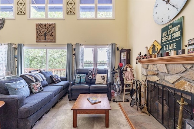 64 Porcupine Point Rd, Tolland, MA 01034 - living area featuring a towering ceiling, healthy amount of natural light, and a fireplace